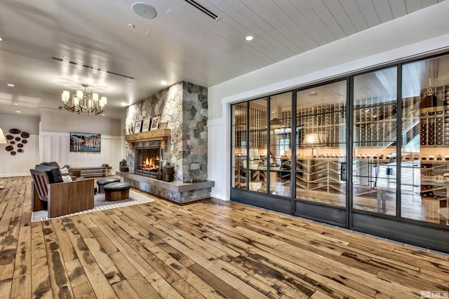 17 Beach Club Dr Unit 221, Stateline, NV 89449 - living room featuring hardwood / wood-style floors, a chandelier, a stone fireplace, and wainscoting