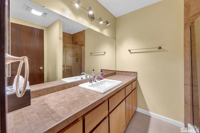 1000 Beck St Unit 251, Reno, NV 89509 - bathroom featuring a tile shower, vanity, and baseboards