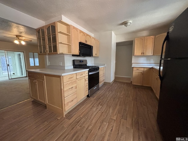 2602 William Ave, South Lake Tahoe, CA 96150 - kitchen with black appliances, light brown cabinetry, dark wood-style flooring, a textured ceiling, and baseboards