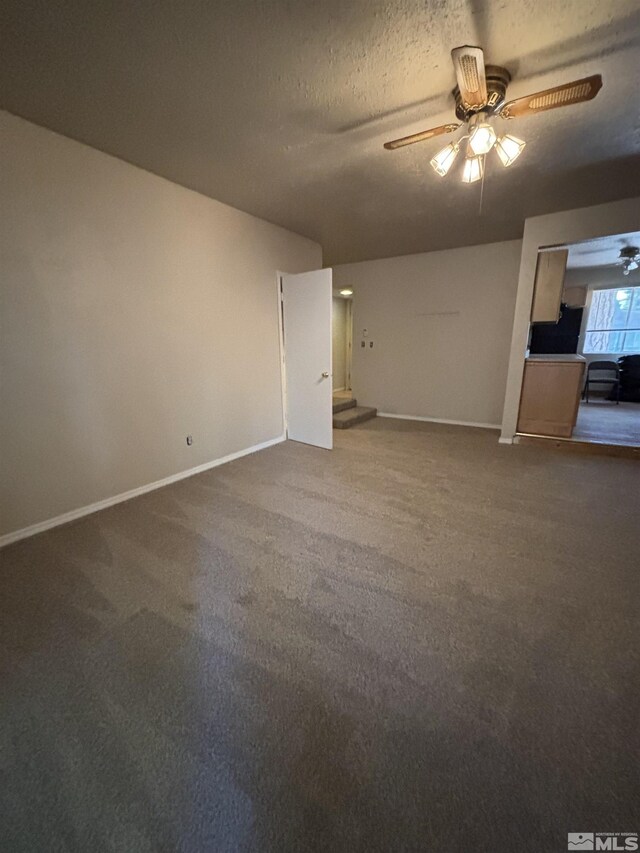 2602 William Ave, South Lake Tahoe, CA 96150 - unfurnished living room with a ceiling fan, baseboards, carpet floors, and a textured ceiling