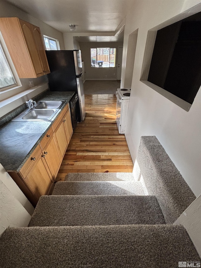 2602 William Ave, South Lake Tahoe, CA 96150 - kitchen with a sink, white electric range, light wood finished floors, light brown cabinetry, and dark countertops