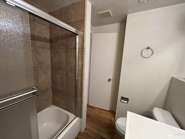 2602 William Ave, South Lake Tahoe, CA 96150 - bathroom with toilet, wood finished floors, and bath / shower combo with glass door