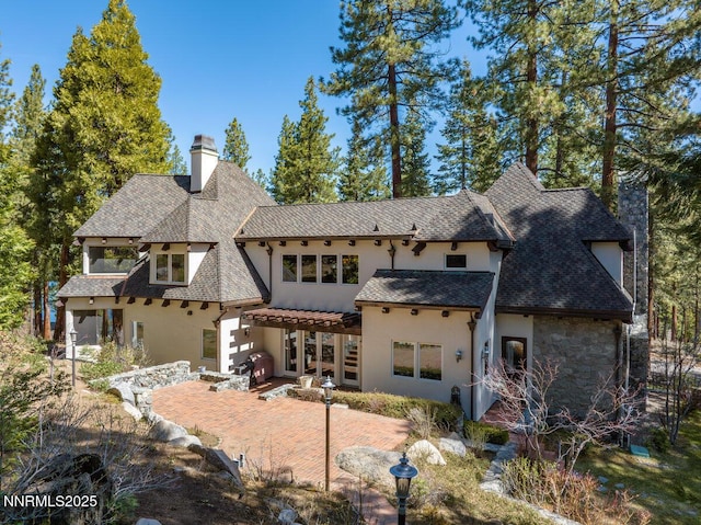 190 Yellow Jacket, Glenbrook, NV 89413 - rear view of property featuring a pergola, stucco siding, a chimney, a patio, and roof with shingles