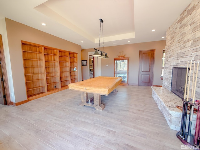 46 Silver Lynx Way, Verdi, NV 89439 - recreation room with billiards, a tray ceiling, recessed lighting, light wood-style flooring, and a fireplace