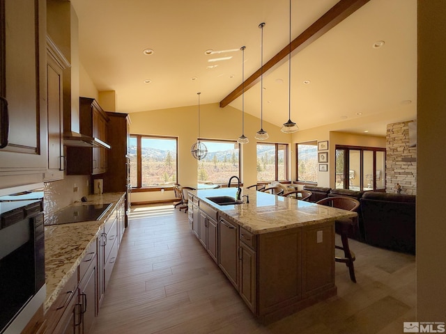 46 Silver Lynx Way, Verdi, NV 89439 - kitchen featuring a sink, beamed ceiling, light wood-style flooring, light stone counters, and black electric stovetop