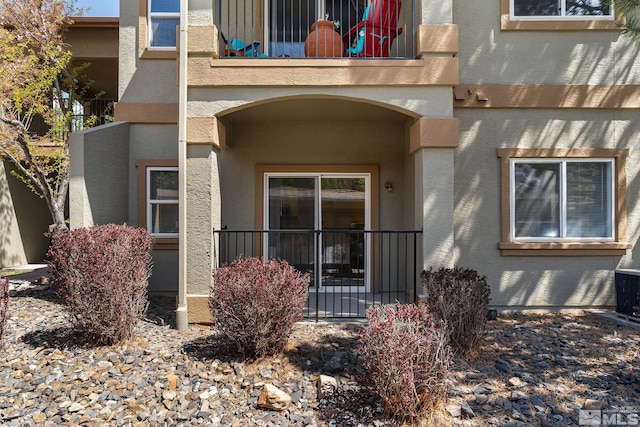 6850 Sharlands Ave Unit Y1149, Reno, NV 89523 - property entrance featuring a balcony, stucco siding, and cooling unit