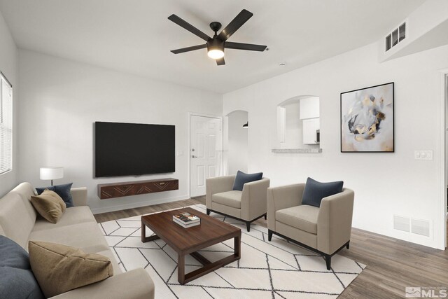6850 Sharlands Ave Unit Y1149, Reno, NV 89523 - living room featuring light wood-type flooring, a ceiling fan, baseboards, and arched walkways