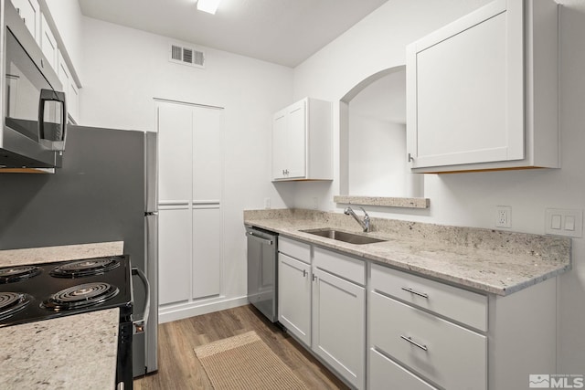 6850 Sharlands Ave Unit Y1149, Reno, NV 89523 - kitchen with stainless steel appliances, a sink, wood finished floors, white cabinetry, and light stone counters
