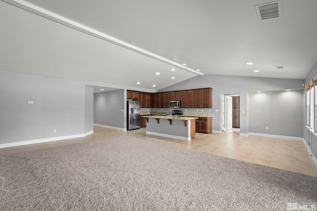 7760 Sonic Ct, Sparks, NV 89436 - kitchen featuring appliances with stainless steel finishes, open floor plan, light tile patterned floors, lofted ceiling, and a breakfast bar