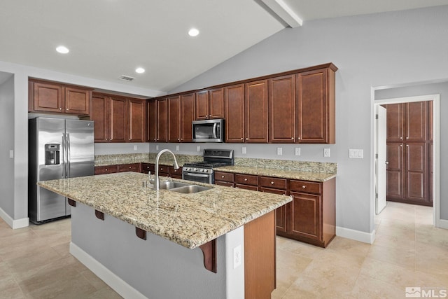 7760 Sonic Ct, Sparks, NV 89436 - kitchen with stainless steel appliances, a sink, a kitchen breakfast bar, light stone counters, and baseboards