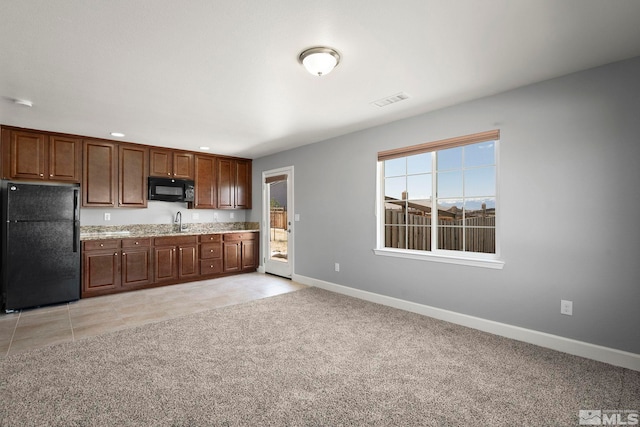 7760 Sonic Ct, Sparks, NV 89436 - kitchen with black appliances, baseboards, a sink, light stone countertops, and recessed lighting