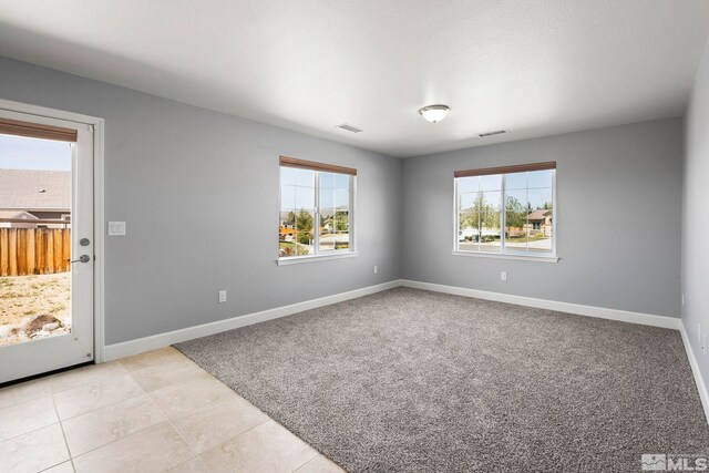 7760 Sonic Ct, Sparks, NV 89436 - empty room featuring baseboards, light tile patterned floors, and light colored carpet