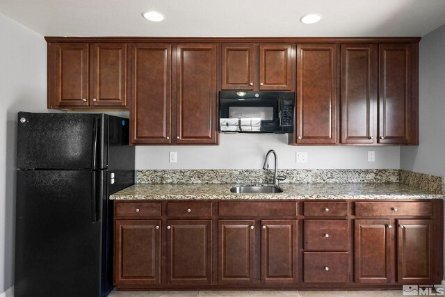 7760 Sonic Ct, Sparks, NV 89436 - kitchen with black appliances, a sink, light stone countertops, dark brown cabinets, and recessed lighting