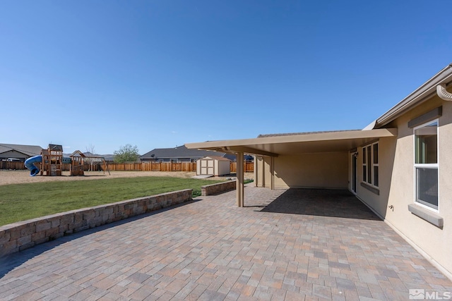 7760 Sonic Ct, Sparks, NV 89436 - view of patio / terrace featuring a shed, a playground, and an outbuilding