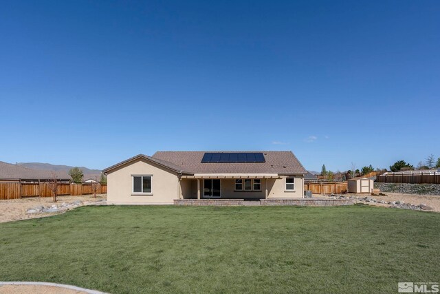 7760 Sonic Ct, Sparks, NV 89436 - rear view of property featuring a storage shed, stucco siding, roof mounted solar panels, an outbuilding, and a patio