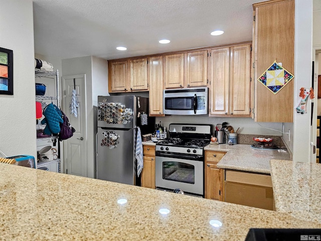 900 S Meadows Pkwy Unit 5414, Reno, NV 89521 - kitchen featuring appliances with stainless steel finishes, light stone counters, and recessed lighting