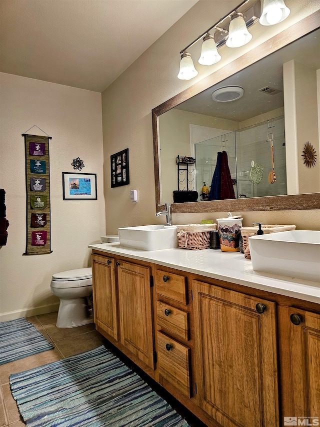 900 S Meadows Pkwy Unit 5414, Reno, NV 89521 - bathroom featuring a stall shower, double vanity, tile patterned flooring, and toilet