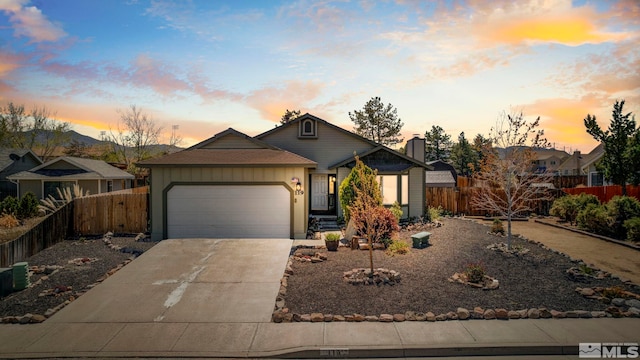 119 River Village Cir, Dayton, NV 89403 - view of front of property featuring a garage, fence, concrete driveway, and board and batten siding