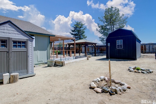 119 River Village Cir, Dayton, NV 89403 - fenced backyard featuring a storage unit, a gazebo, and an outdoor structure