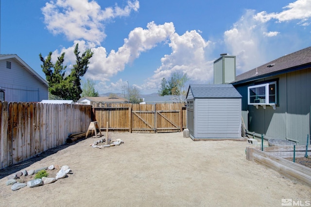 119 River Village Cir, Dayton, NV 89403 - view of patio featuring a fenced backyard, a storage shed, an outdoor structure, and a gate