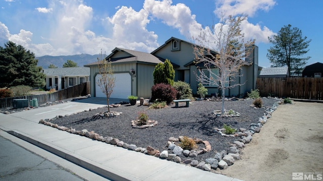 119 River Village Cir, Dayton, NV 89403 - ranch-style home with fence, a garage, concrete driveway, and a mountain view