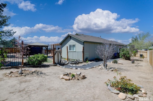 119 River Village Cir, Dayton, NV 89403 - view of side of home featuring a fenced backyard, board and batten siding, and a gazebo