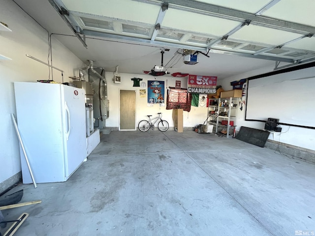 garage featuring freestanding refrigerator and a garage door opener