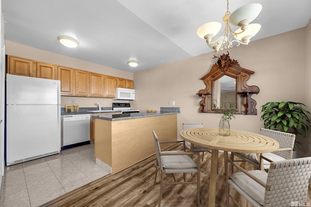 3089 Cashill Blvd, Reno, NV 89509 - kitchen with white appliances, a chandelier, a peninsula, dark countertops, and a sink