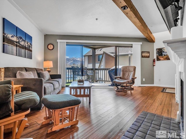 555 Tahoe Keys Blvd Unit 14, South Lake Tahoe, CA 96150 - living room featuring wood-type flooring, beam ceiling, a fireplace, and baseboards
