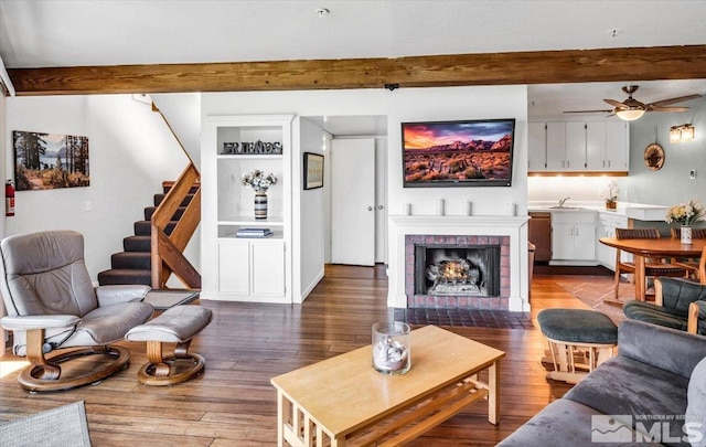555 Tahoe Keys Blvd Unit 14, South Lake Tahoe, CA 96150 - living room featuring beamed ceiling, wood finished floors, ceiling fan, stairs, and a fireplace