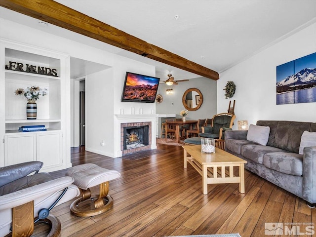 555 Tahoe Keys Blvd Unit 14, South Lake Tahoe, CA 96150 - living room featuring beamed ceiling, wood finished floors, built in shelves, a fireplace, and a ceiling fan