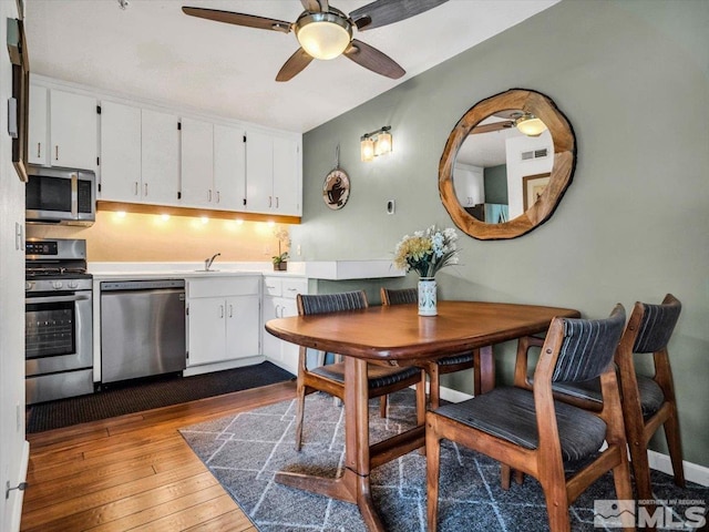555 Tahoe Keys Blvd Unit 14, South Lake Tahoe, CA 96150 - kitchen with stainless steel appliances, a ceiling fan, dark wood-type flooring, white cabinets, and light countertops