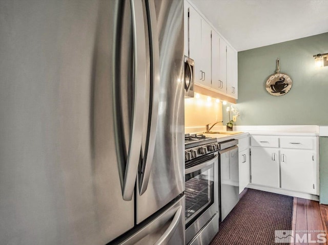555 Tahoe Keys Blvd Unit 14, South Lake Tahoe, CA 96150 - kitchen with stainless steel appliances, white cabinets, light countertops, a sink, and dark wood-type flooring