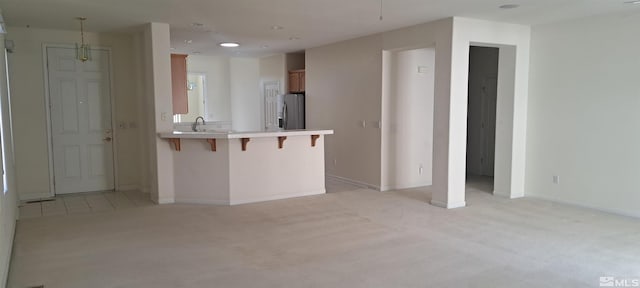1360 Veneto Dr, Sparks, NV 89434 - kitchen featuring stainless steel fridge with ice dispenser, light carpet, a peninsula, a breakfast bar, and recessed lighting