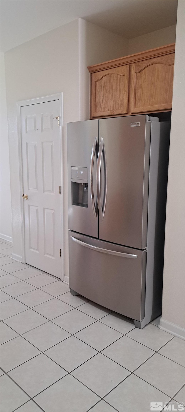 1360 Veneto Dr, Sparks, NV 89434 - kitchen featuring stainless steel fridge with ice dispenser, light tile patterned flooring, baseboards, and brown cabinets