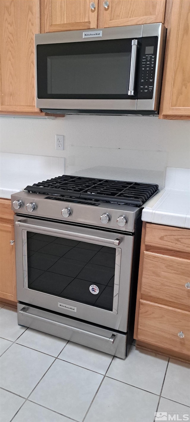 1360 Veneto Dr, Sparks, NV 89434 - kitchen with appliances with stainless steel finishes, light tile patterned floors, and light countertops