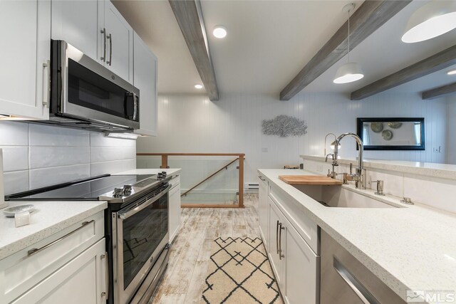 989 Tahoe Blvd Unit 36, Incline Village, NV 89451 - kitchen featuring appliances with stainless steel finishes, a sink, beam ceiling, light wood-style flooring, and pendant lighting