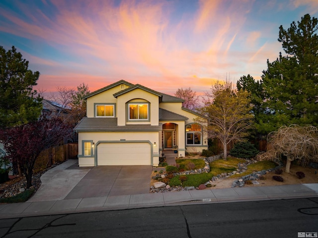 2900 Ariel Dr, Reno, NV 89523 - view of front of house featuring stucco siding, fence, a garage, and concrete driveway
