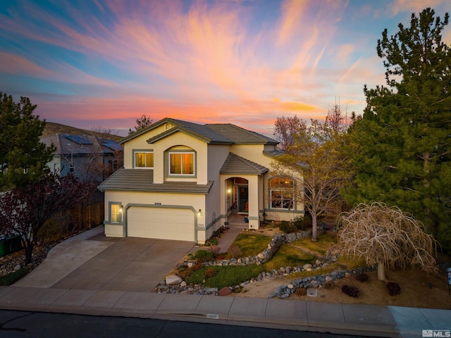 2900 Ariel Dr, Reno, NV 89523 - view of front of home featuring stucco siding, a garage, a tiled roof, and driveway
