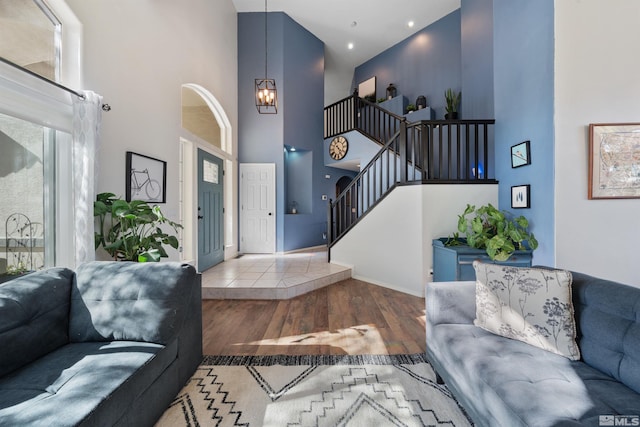 2900 Ariel Dr, Reno, NV 89523 - living room with a towering ceiling, wood finished floors, stairs, a chandelier, and baseboards