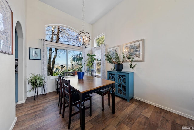 2900 Ariel Dr, Reno, NV 89523 - dining area featuring a chandelier, high vaulted ceiling, dark wood-style flooring, baseboards, and arched walkways
