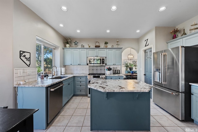 2900 Ariel Dr, Reno, NV 89523 - kitchen with appliances with stainless steel finishes, a sink, backsplash, recessed lighting, and a kitchen island