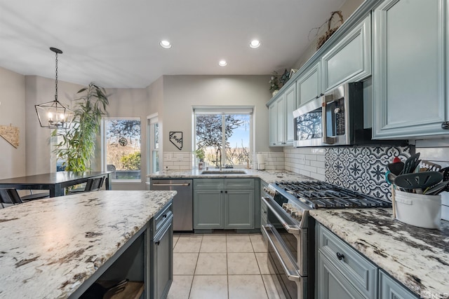 2900 Ariel Dr, Reno, NV 89523 - kitchen with stainless steel appliances, a sink, a chandelier, tasteful backsplash, and recessed lighting