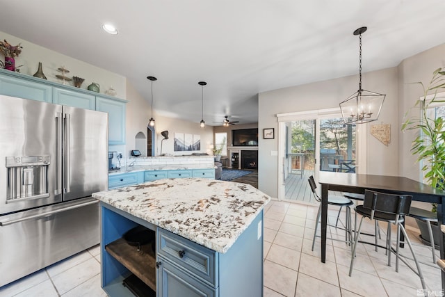 2900 Ariel Dr, Reno, NV 89523 - kitchen with high end refrigerator, blue cabinetry, light tile patterned flooring, a chandelier, and recessed lighting