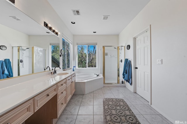 2900 Ariel Dr, Reno, NV 89523 - full bathroom featuring vanity, a shower stall, a garden tub, and tile patterned flooring