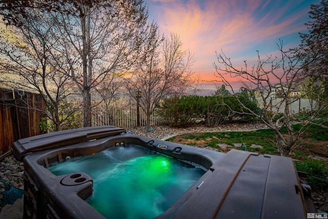 2900 Ariel Dr, Reno, NV 89523 - pool at dusk with a hot tub and fence