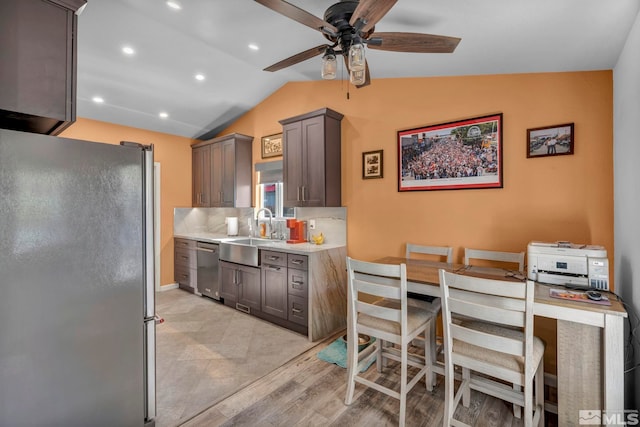 233 Jennys Ln, Fernley, NV 89408 - kitchen featuring appliances with stainless steel finishes, a sink, vaulted ceiling, light countertops, and a ceiling fan