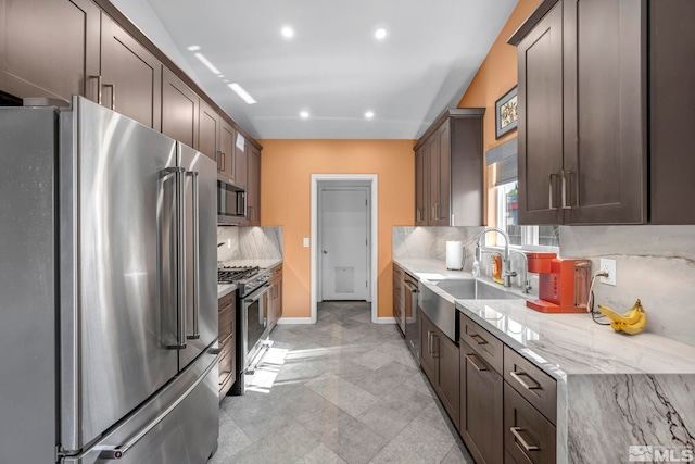 233 Jennys Ln, Fernley, NV 89408 - kitchen with high quality appliances, a sink, decorative backsplash, baseboards, and recessed lighting