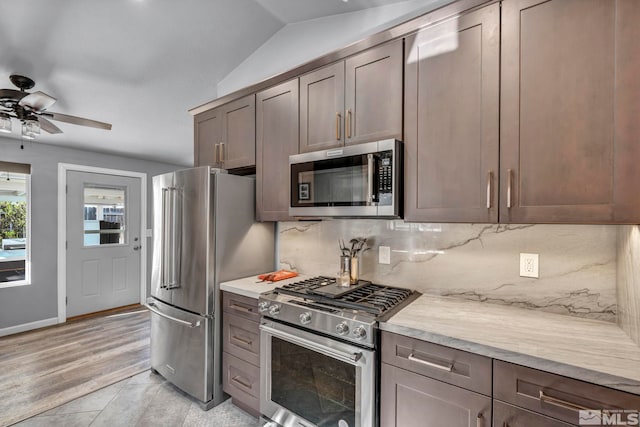 233 Jennys Ln, Fernley, NV 89408 - kitchen with appliances with stainless steel finishes, light countertops, backsplash, a ceiling fan, and vaulted ceiling