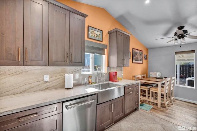 233 Jennys Ln, Fernley, NV 89408 - kitchen featuring stainless steel dishwasher, vaulted ceiling, healthy amount of natural light, a ceiling fan, and a sink